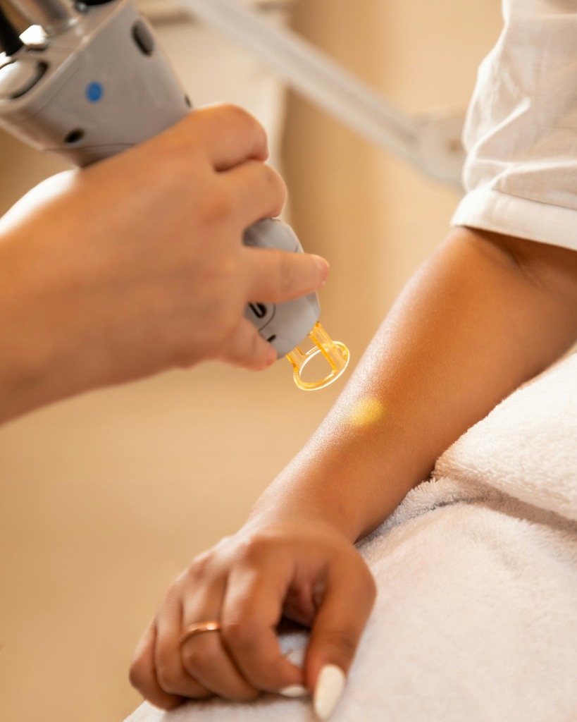 Laser hair removal procedure with a technician and patient